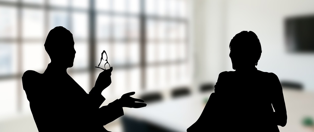 two people visiting at table